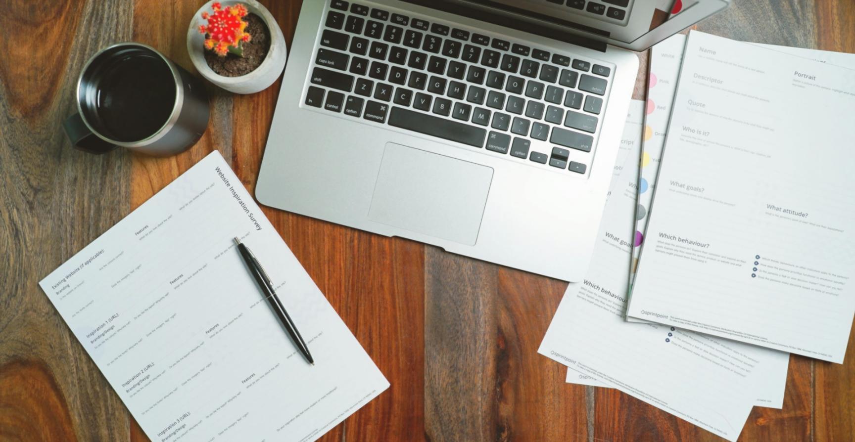 Budget planning worksheets and financial documents spread on a desk
